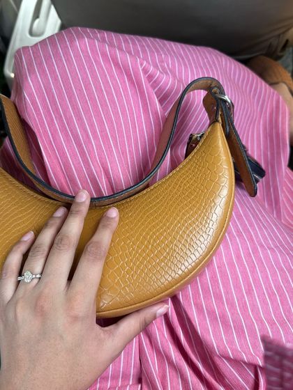My go-to bag for the last three years, the Selena Tan Croc. Here it is, resting on my lap, a trusted companion for every occasion.