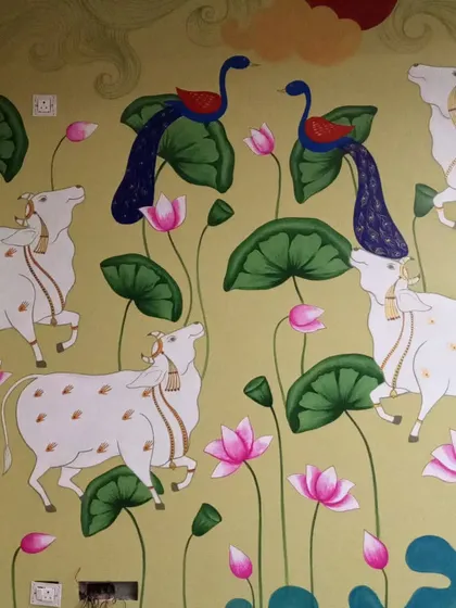 Another view of the Pichwai mural, showing the playful peacocks and cows among the lotus ponds. This style of art tells stories and brings a sense of calm and culture to any home.