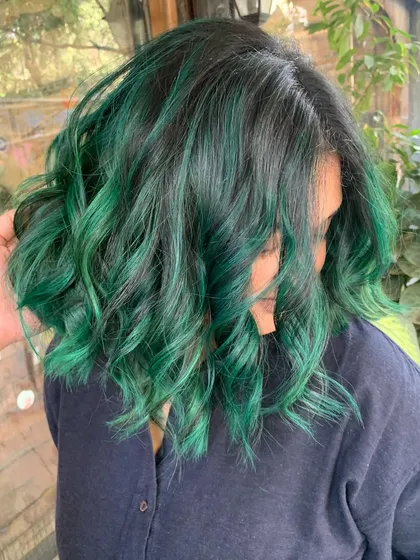 A side view of the emerald green look. The color is bold and confident, just like the client.