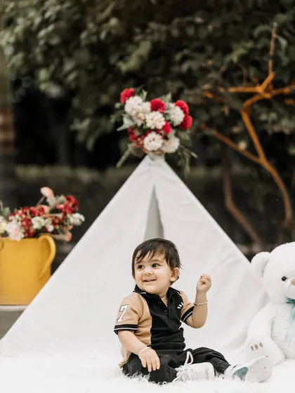 A sweet, candid moment from a first birthday session. The simple joy on his face as he sits in our teepee setup is a memory his parents will cherish.
