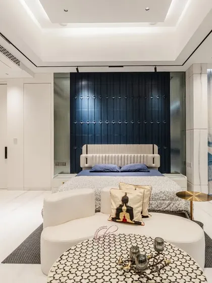 This wide shot captures the entire bedroom, emphasizing its spaciousness and the cohesive design. The balance of colors, textures, and light creates a truly inviting and luxurious environment.