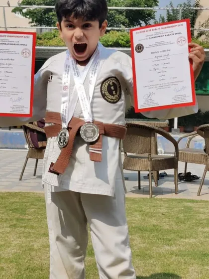 The pure joy of achievement! One of my students lets out a victory roar while holding his certificates and medals. This is what passion and hard work look like.