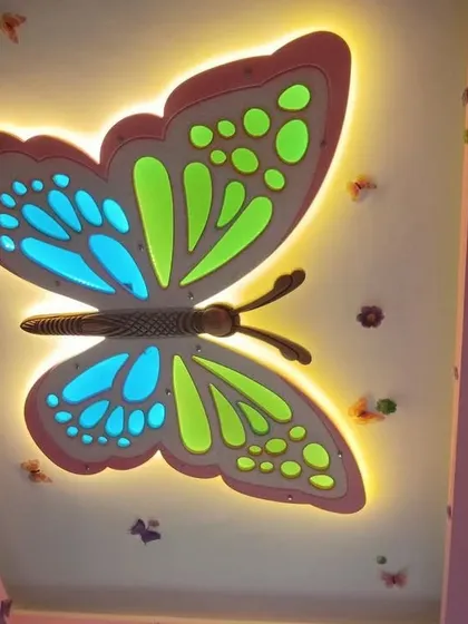 I love bringing imagination to life, especially in kids' rooms. This custom butterfly-shaped false ceiling uses multi-colored LED backlighting to create a playful and magical atmosphere that your children will adore.