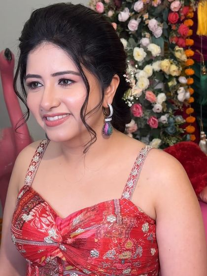 Rashmi looks happy and radiant, ready for her Mehendi ceremony. The makeup is light and fresh, perfect for the festive atmosphere.