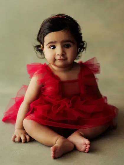 Another adorable portrait from a sitter session. The simple red dress and clean background make her the star of the show.