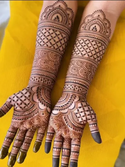 A classic bridal design with repeating geometric patterns that are both traditional and timeless. The solid fingertips complete the look.