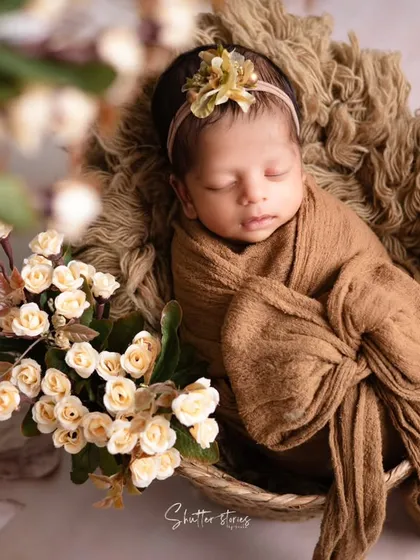 This angle highlights the basket and the arrangement of props around the baby, showing how to build a complete, layered scene.