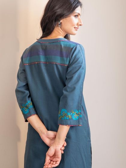 The back of our Haveli Crewel Blue Kurta features a contrasting striped panel, adding a modern touch to this traditional piece.
