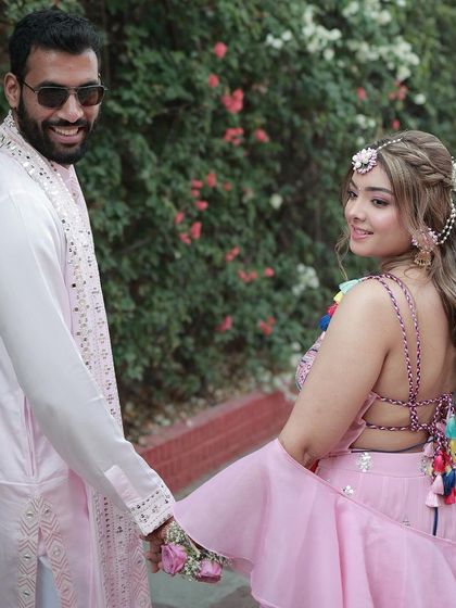 That "look back" moment. The bride and groom look perfect together, with her colorful Mehendi outfit and my fresh, radiant makeup.