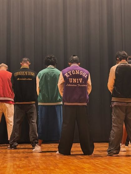 The stage is set and the excitement is building. Our dancers, in their varsity jackets, are ready to bring their A-game.