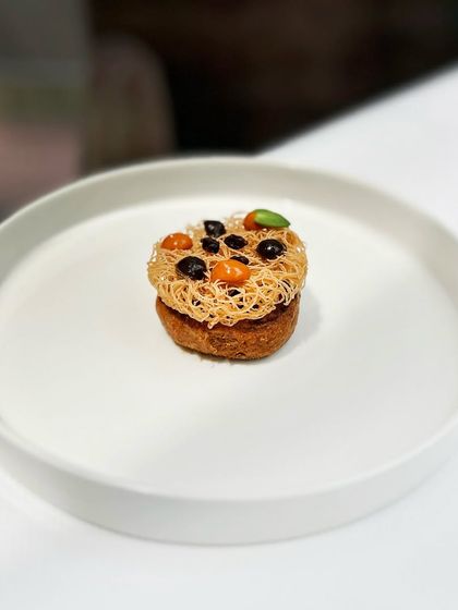 Our smoked duck shaami is a refined take on the classic kebab, topped with crispy seviyan and a sweet barberry chutney. It's a perfect balance of smoky, sweet, and savoury.