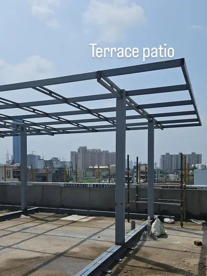 The structural framework for a large terrace patio and trellis. This steel structure is the foundation for a future landscaped outdoor living area, designed to provide shade and a sense of enclosure.