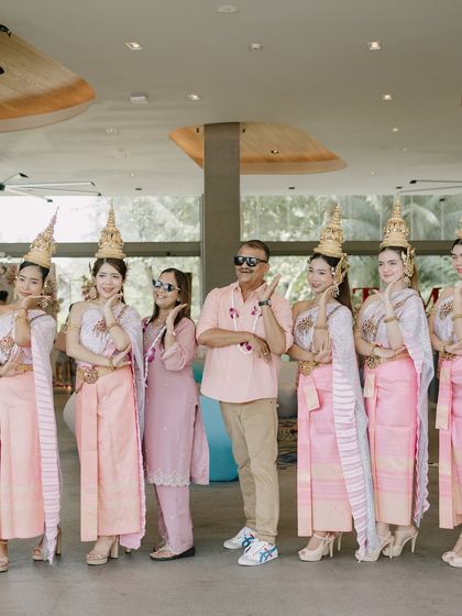 Guests posing with traditional Thai dancers. These interactive moments make for great photos and even better memories, fully immersing everyone in the destination experience.