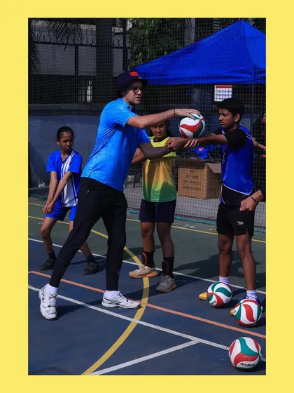 A hands-on correction for a young player's setting form. This direct feedback ensures they develop the right habits early on.