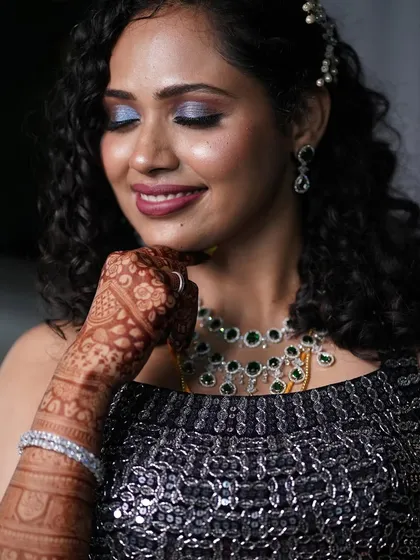 A close-up of her gorgeous makeup look. The shimmering blue eyeshadow and flawless skin pair beautifully with her natural hair.