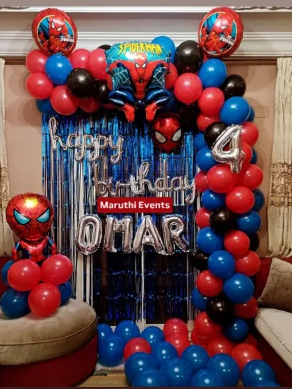 This Spiderman decor is perfect for home celebrations. It features a balloon arch in classic red, blue, and black, a shiny blue foil curtain, and Spiderman character balloons for a super-powered birthday.