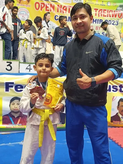 This young student is happy to receive his bronze medal at the national championship.