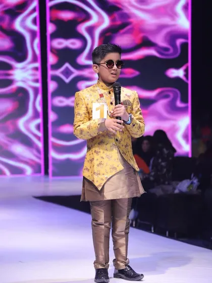 A photo from a previous event, showing this contestant's experience on stage.