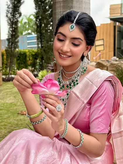 A dreamy South Indian bridal look in the softest pastel pink. I paired a gentle pink eyeshadow with radiant skin to complement her emerald and diamond jewellery, creating a look of pure, effortless elegance.