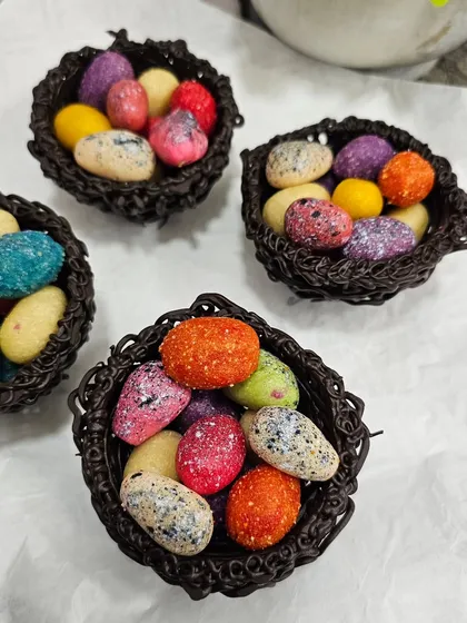The colorful speckled marzipan eggs in their chocolate nests.