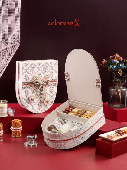 The shield box opens to reveal a well-organized interior with compartments for sweets and jars, showing that our designs are as functional as they are beautiful.