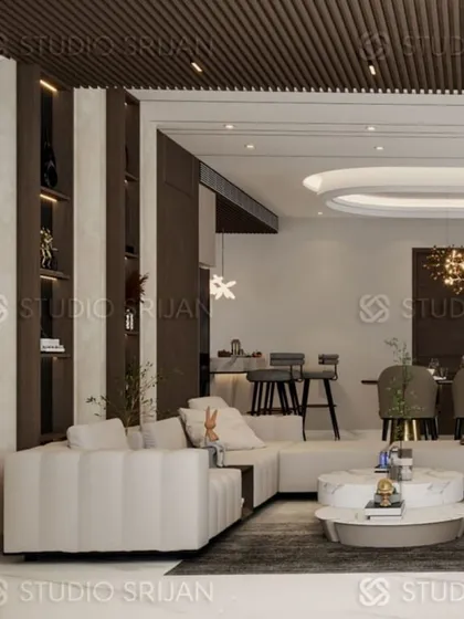 This Krishna Park lobby and dining area showcases a rich material palette, including dark wood, black marble, and plush, light-colored sofas for a high-contrast, luxurious feel.