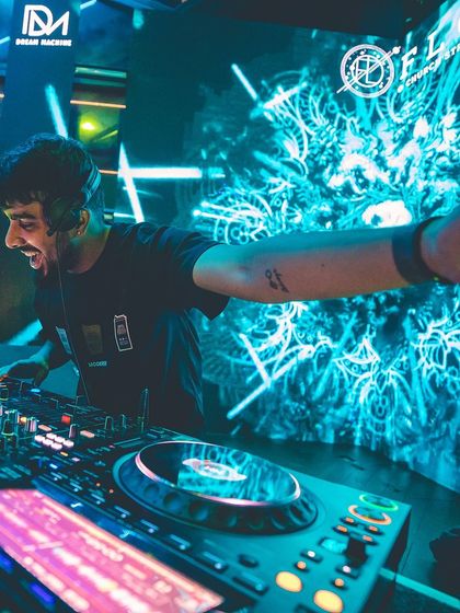 A selfie from the DJ booth, with the psychedelic visuals and my Pioneer setup in full view. This is my office.