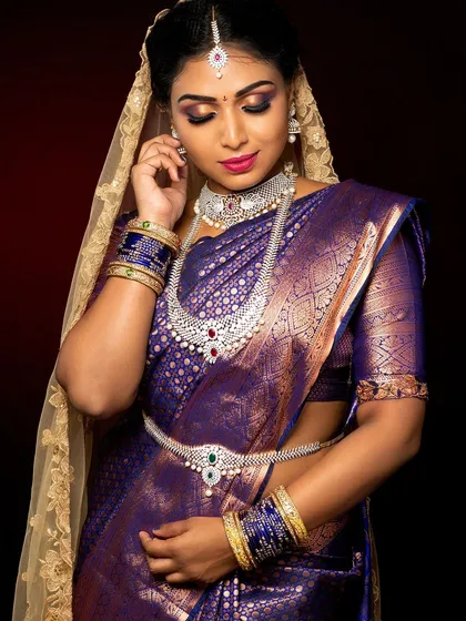 I have extensive experience with South Indian bridal styles. This portrait showcases the rich colors, intricate diamond jewelry, and classic makeup that defines this beautiful tradition.
