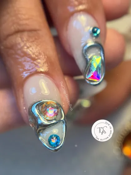 A close-up of the abstract 3D silver chrome design, showing how the iridescent jewels are nestled within the metallic structure.