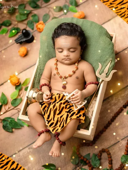 We celebrate faith and tradition with themes like this 'Little Mahadev' setup. Complete with a miniature trishul and damru, it’s a powerful way to honor your beliefs in your baby's first photoshoot.