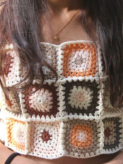 A front-on view of the granny square crop top, showcasing the pattern and the flattering square neckline.