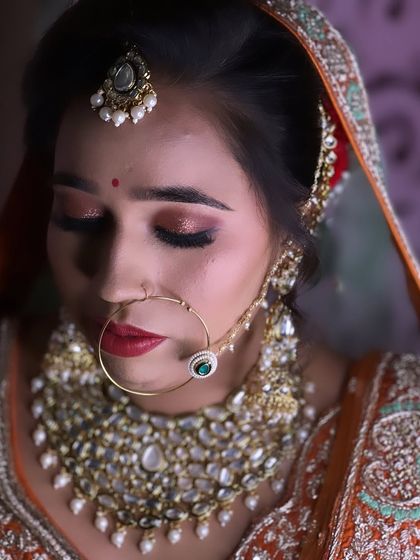A close up of a bride with soft, shimmery eye makeup and a bold red lip. A classic and timeless combination.
