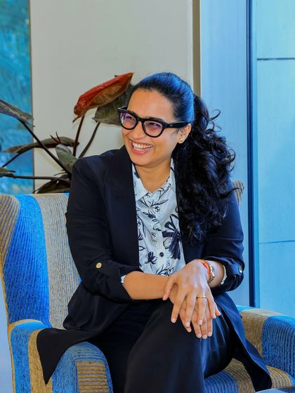 A relaxed and happy candid from a corporate meet. My formal attire, a black blazer and printed shirt, is perfect for professional yet stylish events.