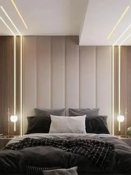 I create serene and luxurious master bedrooms that feel like a personal retreat. This design uses a combination of vertical wood paneling, a plush upholstered headboard, and layered ambient lighting to build a warm and inviting atmosphere.