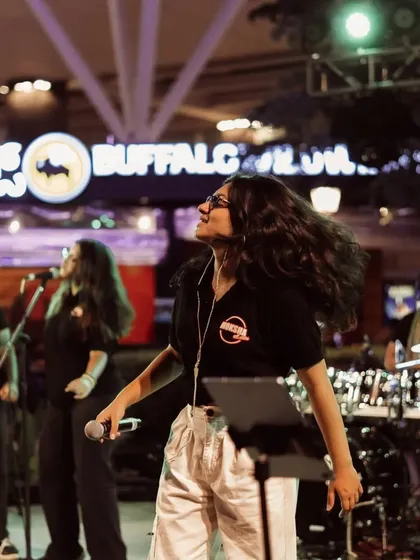 My hair really does have a mind of its own during an energetic performance. A candid shot from our show with the Moksha All Stars, capturing the pure joy and freedom of being on stage.