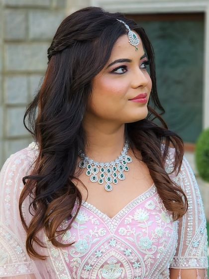 In love with this pastel fairy look. The soft pink lehenga is paired with a subtle smokey eye and a braided half-updo for a romantic and modern style.