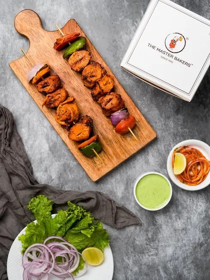 Another look at our Tandoori Soya Chaap, presented with a side of pickled onions and mint chutney. The rich marinade gives each piece a deep, savory flavor that's both hearty and delicious.
