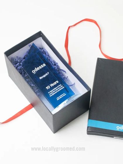 A closer view of the 10-year service award for Odessa. The gift box includes the custom acrylic trophy, showing how we present our recognition items with care.