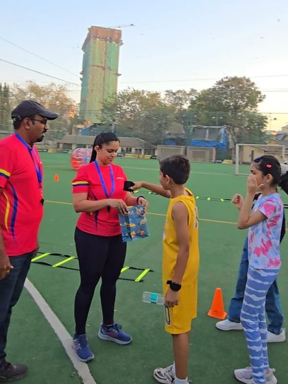 A moment of recognition as a child receives a small prize. We believe in celebrating effort and participation, making every child feel like a winner.