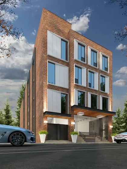 A commercial building with a classic brick facade, updated with modern, large windows and clean lines. The design is intended to fit within an urban context while offering a contemporary workspace.