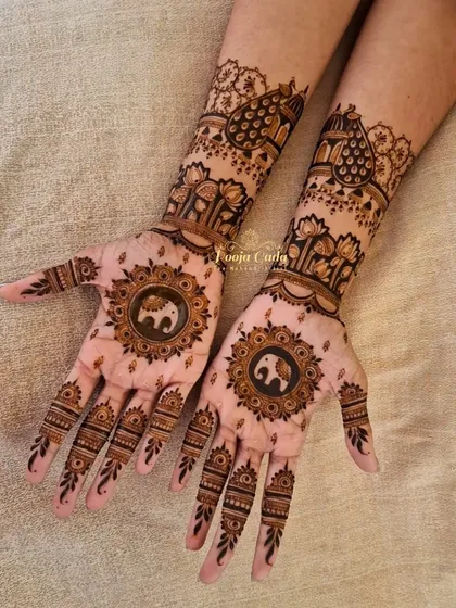 A lovely Karwa Chauth design featuring central mandalas with small elephants. The back of the hands are adorned with lotus patterns and peacock-inspired shapes for a balanced and festive look.