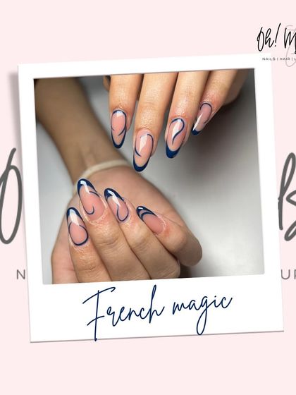 French tips, but make it art. This design uses a bold navy blue polish to create abstract, free-flowing lines over a clean, neutral base for a modern and chic look.