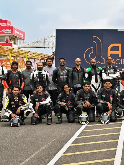 The crew at Kari Motor Speedway, posing on the track after three intense days of riding and learning together.