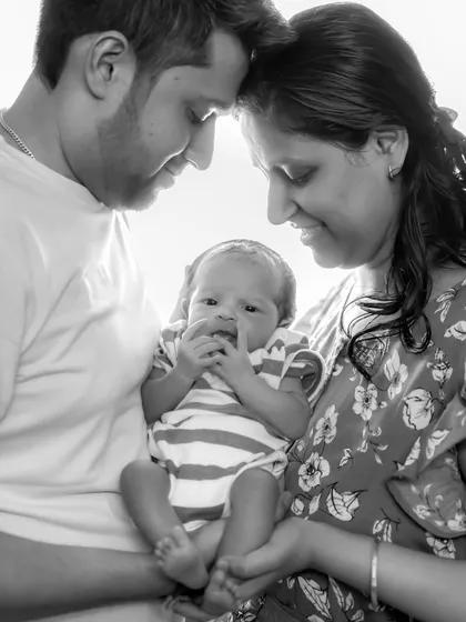 The beginning of a new family story. This black and white portrait captures the tender, loving bond between new parents and their precious newborn, a timeless memory to hold onto forever.