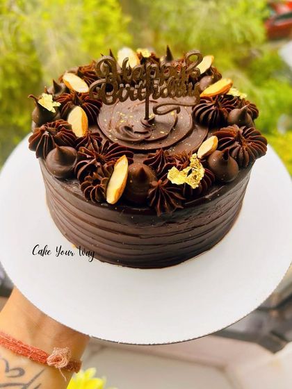 For the ultimate chocolate lover, my Belgian chocolate cake is pure heaven. It features a rich, dark chocolate sponge, silky chocolate ganache, and is decorated with chocolate piping, almond slivers, and a touch of gold leaf.