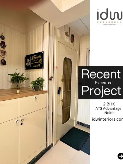 A welcoming entryway with a custom nameplate and practical shoe storage. The vertical wall fluting adds texture and a modern touch.