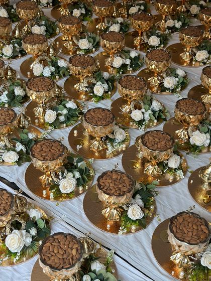 For a grand wedding, the client wanted opulent return favours. I created these golden platters, each holding a bowl of premium almonds and surrounded by white roses, to give guests a taste of luxury.