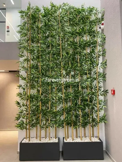 A clean and modern privacy screen created using tall, realistic artificial bamboo plants in sleek black planters. This is a perfect solution for dividing spaces in offices or homes while maintaining a light and airy feel.