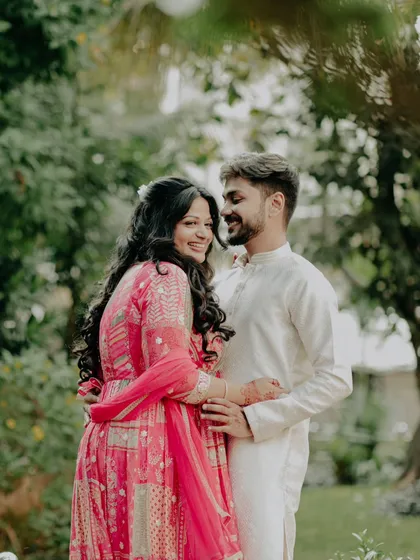 A beautiful couple portrait from an engagement day. The bride's makeup is natural and elegant, perfect for an outdoor setting.