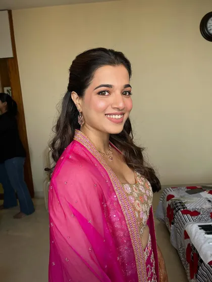 A close-up showing the beautiful smile and the soft, glowing makeup. This look is all about enhancing her features in the most natural way.